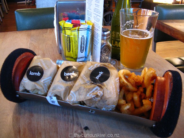 Open cannister containing 3 sliders and curly fries - $20 at C1 Espresso
