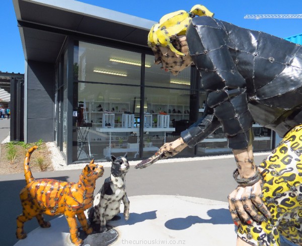 Tanya Brown feeding cats at Re:START by sculptor Hannah Kidd
