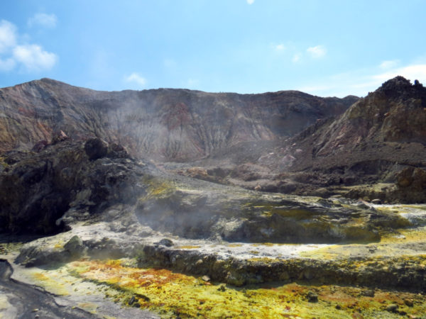 A hot water stream, sulphur crystals and the rugged interior of the White Island crater